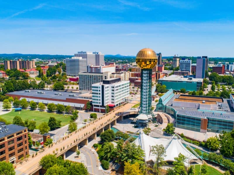 Land surveying in Knoxville Tennessee featuring the Sunsphere, downtown skyline, and surrounding urban landscape