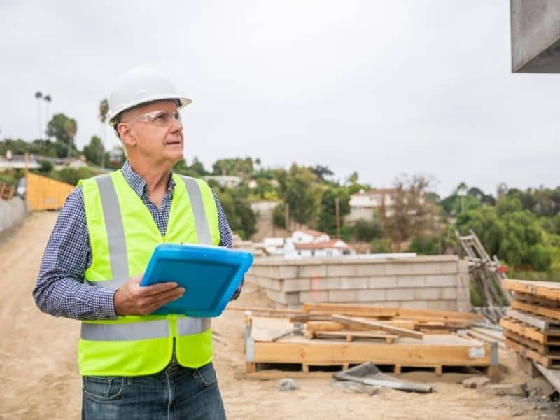 Construction professional reviewing site progress during a multi-phase development project in Knoxville.