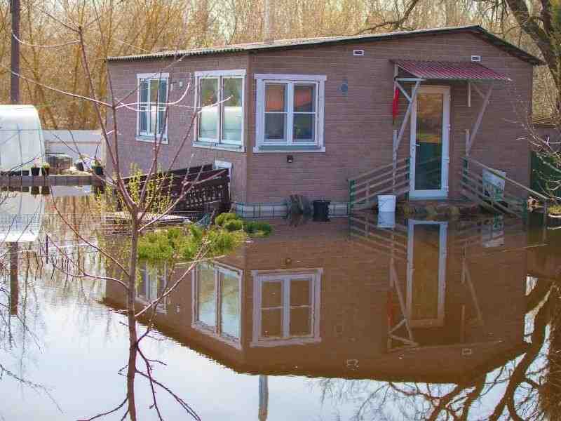Measuring a flood-prone home foundation to prepare an elevation certificate for insurance and property review
