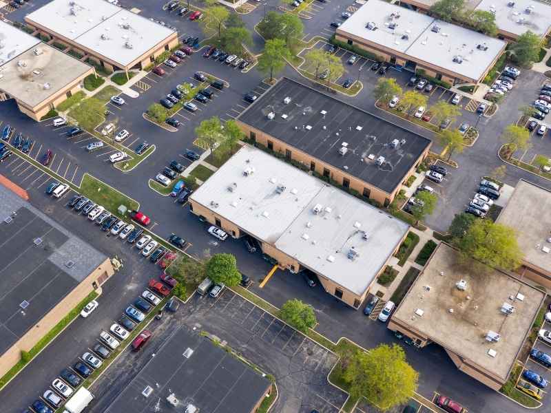 Aerial view of a multi-tenant commercial property with multiple buildings, shared parking areas, and access drives in Knoxville, Tennessee.